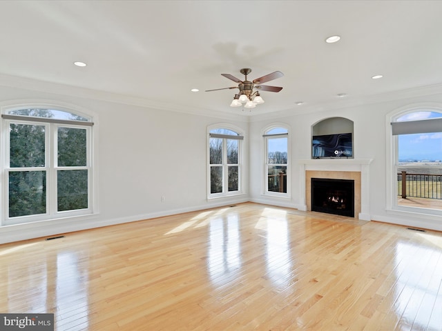 unfurnished living room featuring crown molding, ceiling fan, and light hardwood / wood-style flooring