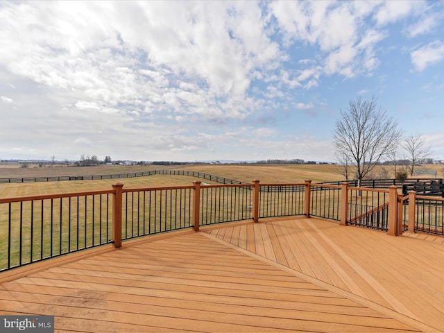 wooden deck with a yard and a rural view