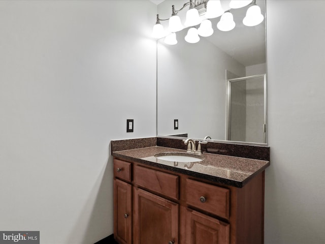 bathroom featuring vanity and a shower with door