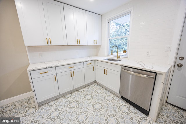 kitchen with white cabinetry, stainless steel dishwasher, light stone countertops, and sink