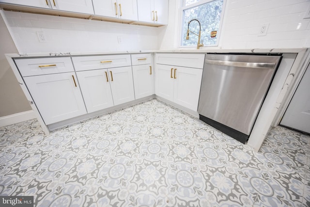 kitchen with white cabinetry, backsplash, stainless steel dishwasher, and sink