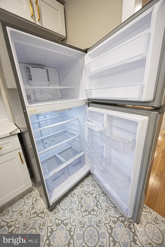 details featuring fridge and white cabinets