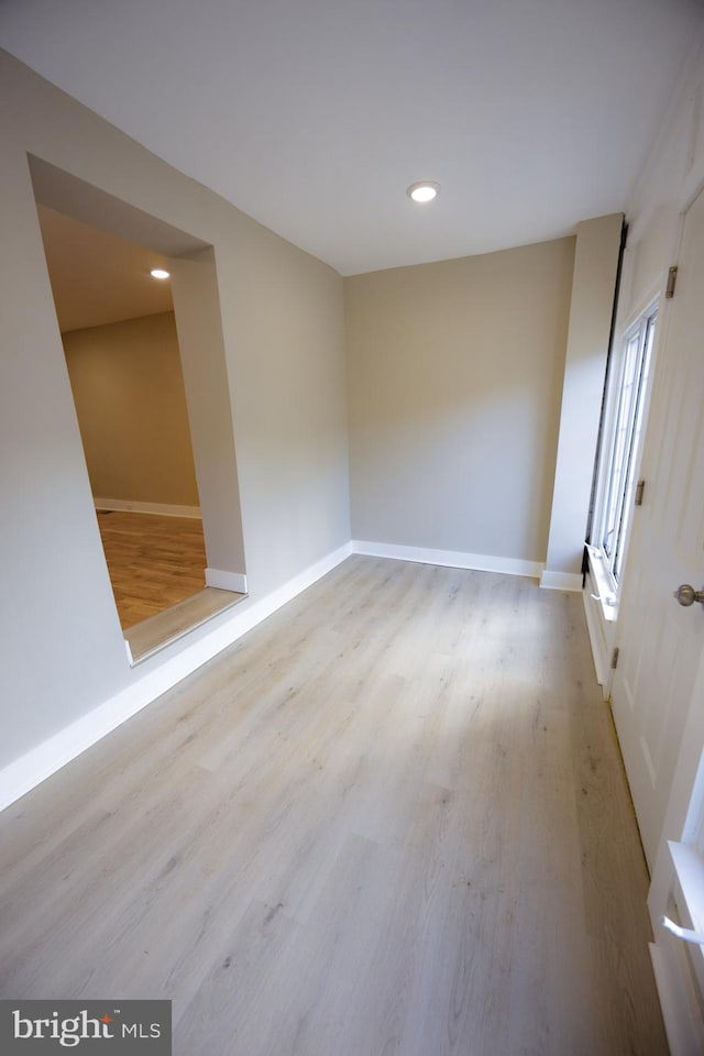 empty room with light hardwood / wood-style flooring