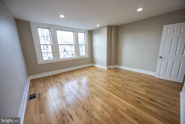 unfurnished room with light wood-type flooring