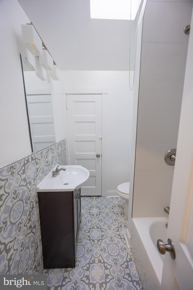 full bathroom featuring tile patterned floors, vanity, toilet, and shower / bath combination