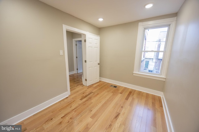 empty room with light hardwood / wood-style floors