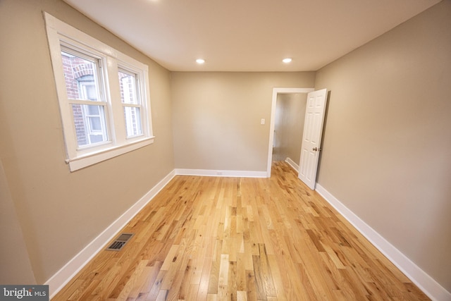 unfurnished room with light wood-type flooring