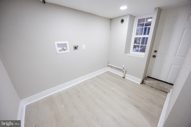 washroom with hookup for a washing machine, electric dryer hookup, hookup for a gas dryer, and light hardwood / wood-style flooring