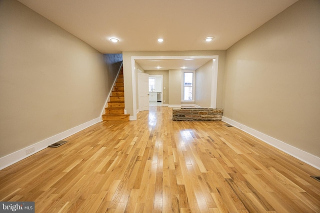 unfurnished living room featuring light wood-type flooring