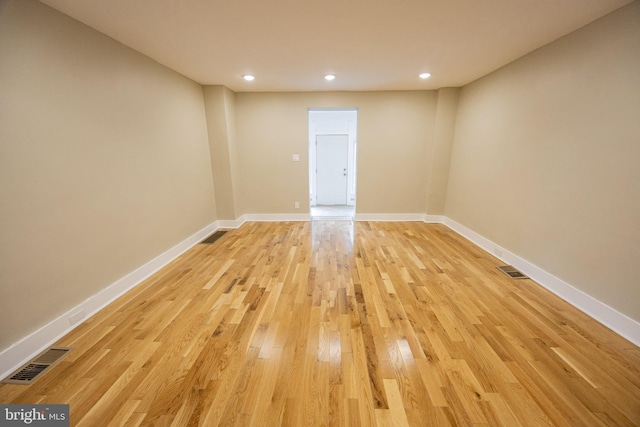 empty room with light hardwood / wood-style flooring