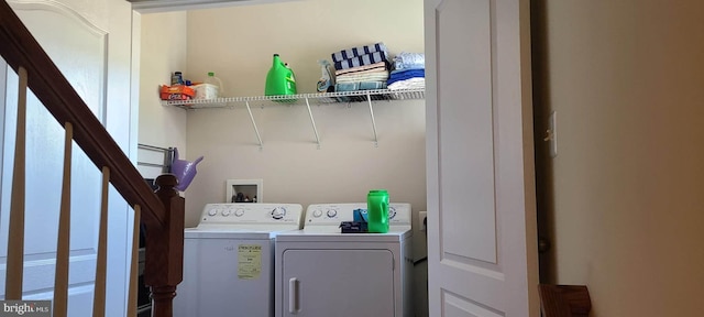 clothes washing area featuring separate washer and dryer