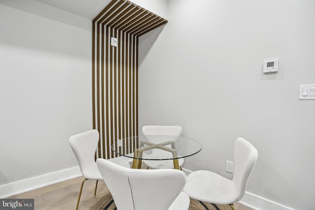 dining space with light hardwood / wood-style floors