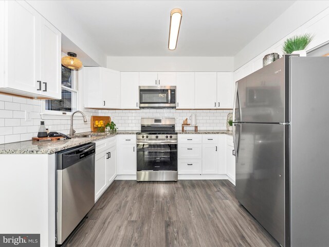 kitchen featuring white cabinetry, appliances with stainless steel finishes, and light stone counters