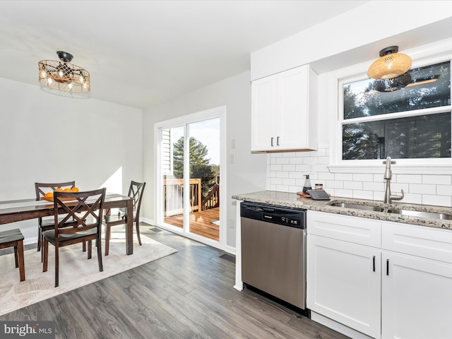 kitchen featuring sink, stainless steel dishwasher, white cabinets, light stone countertops, and backsplash