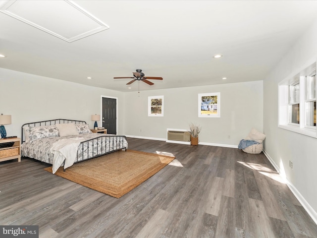 bedroom with ceiling fan, dark hardwood / wood-style flooring, and heating unit