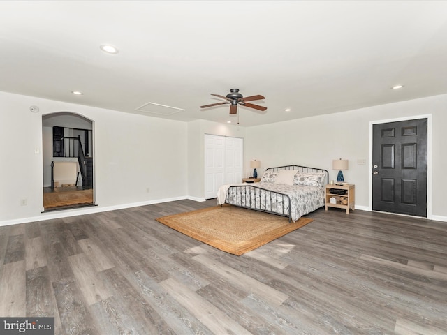 unfurnished bedroom featuring ceiling fan, wood-type flooring, and a closet