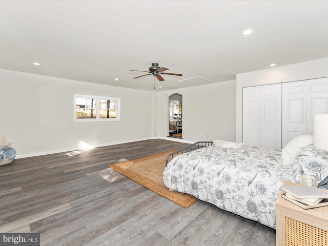 bedroom featuring wood-type flooring, ceiling fan, and a closet