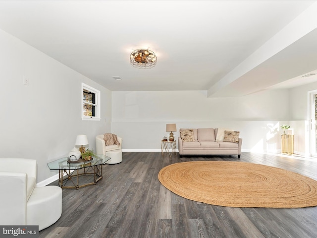 sitting room featuring a healthy amount of sunlight and dark hardwood / wood-style flooring