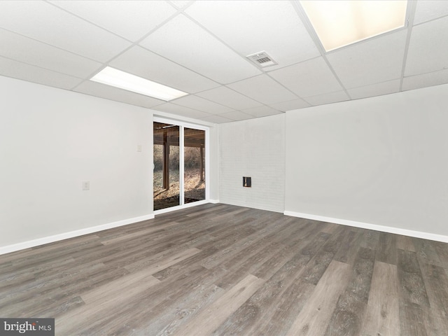 empty room featuring hardwood / wood-style floors and a drop ceiling