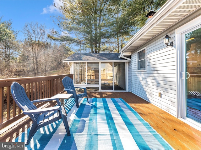 wooden deck with a sunroom