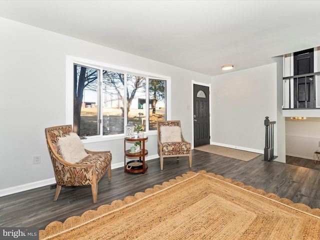 sitting room with dark hardwood / wood-style flooring