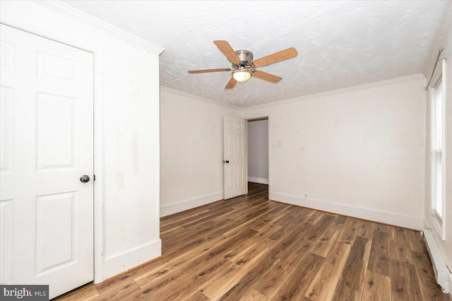 unfurnished bedroom with crown molding, baseboards, a textured ceiling, baseboard heating, and wood finished floors