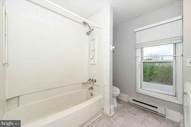 full bathroom with a baseboard radiator, toilet, bathtub / shower combination, and baseboards