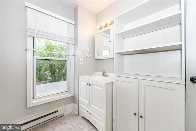 bathroom featuring a baseboard radiator, vanity, tile patterned flooring, and baseboards