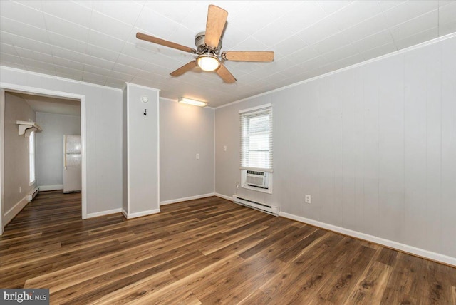 empty room with wood finished floors, baseboard heating, ornamental molding, ceiling fan, and baseboards