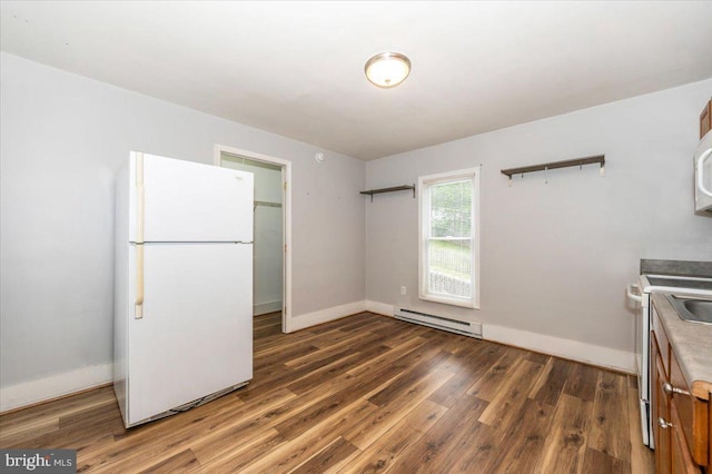 kitchen featuring baseboards, wood finished floors, white appliances, and a baseboard heating unit