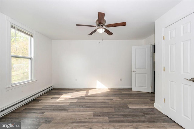 unfurnished room with wood finished floors, ceiling fan, a baseboard heating unit, and baseboards
