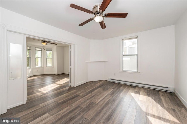 unfurnished room with baseboards, ceiling fan, baseboard heating, and dark wood-type flooring