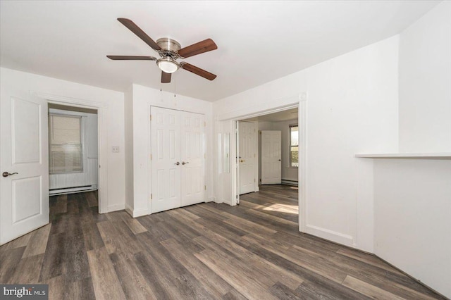unfurnished bedroom featuring wood finished floors, a closet, and baseboards