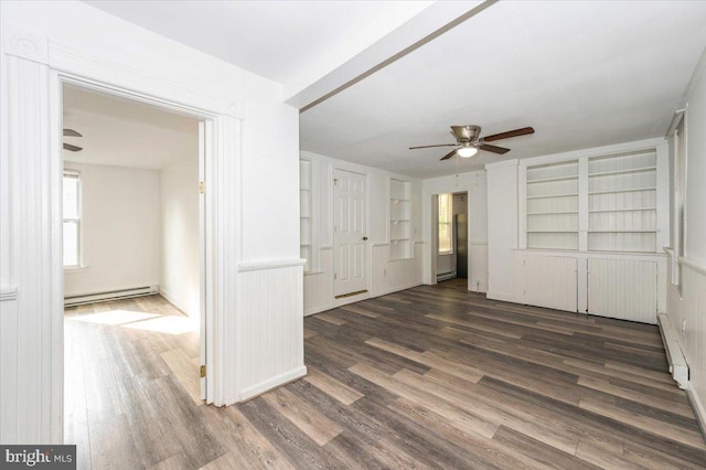 unfurnished bedroom featuring a baseboard heating unit, a ceiling fan, baseboard heating, and wood finished floors