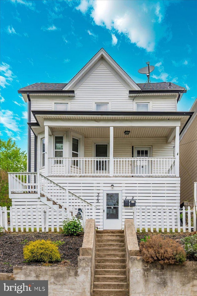 view of front of home with stairs and covered porch