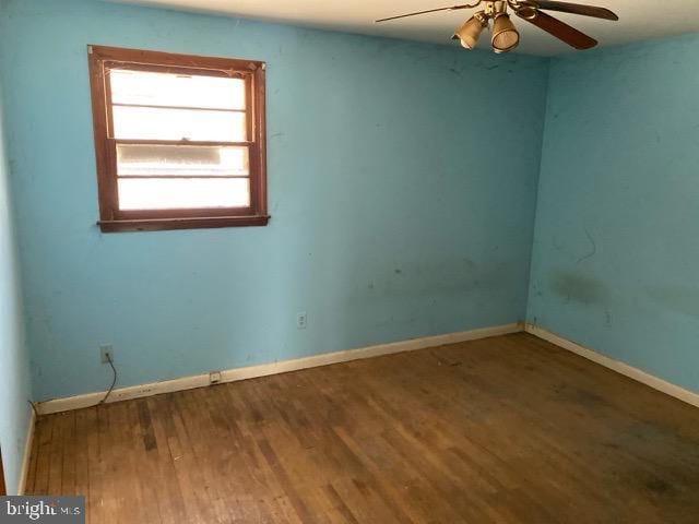 empty room featuring wood-type flooring and ceiling fan