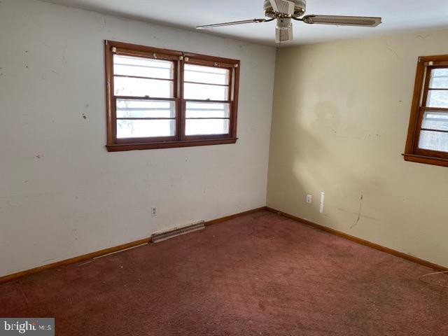 carpeted empty room with ceiling fan