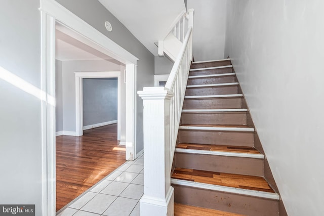 staircase featuring tile patterned floors