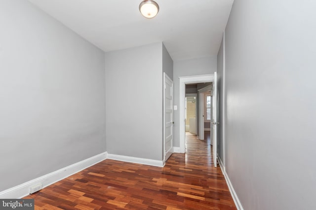 hall with dark hardwood / wood-style floors