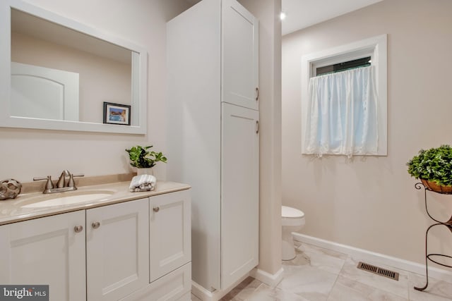 bathroom featuring vanity and toilet