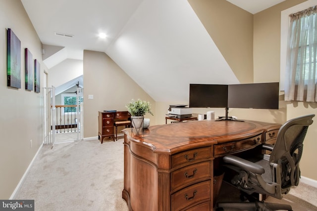 office space with vaulted ceiling and light colored carpet