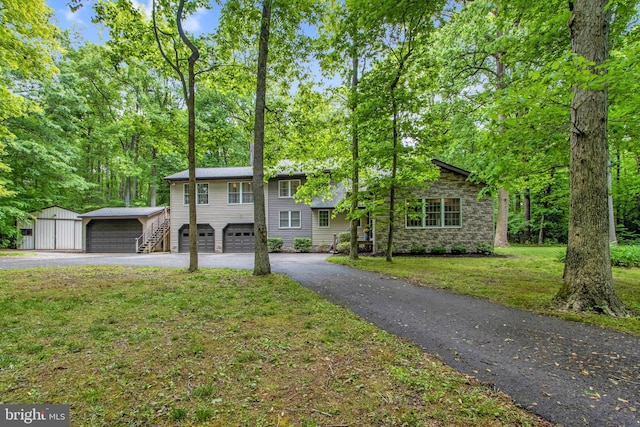 view of front of property with a front yard and a storage shed