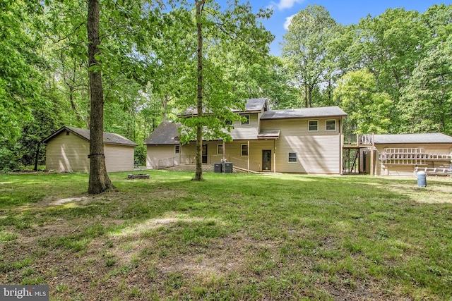 rear view of house featuring a yard