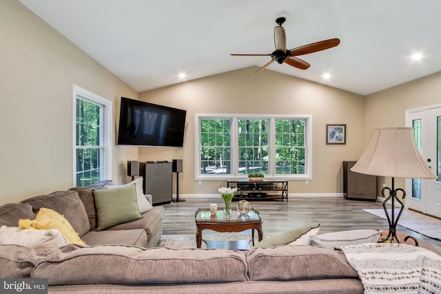 living room featuring ceiling fan, lofted ceiling, and light hardwood / wood-style floors