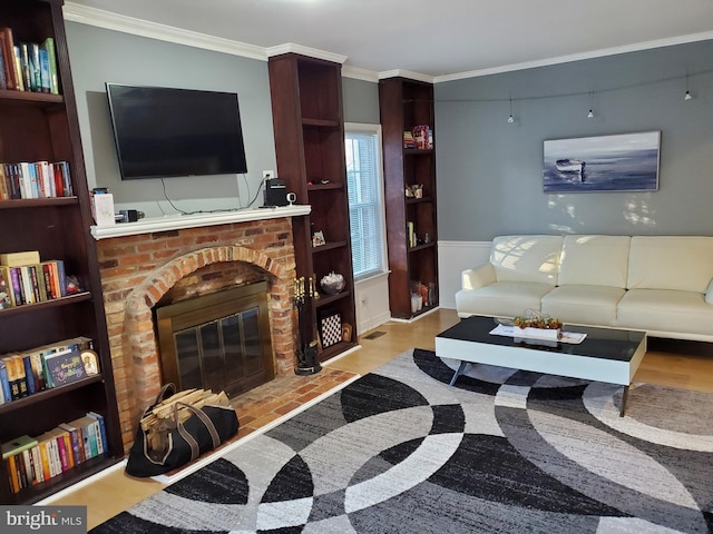 living room featuring a brick fireplace and crown molding