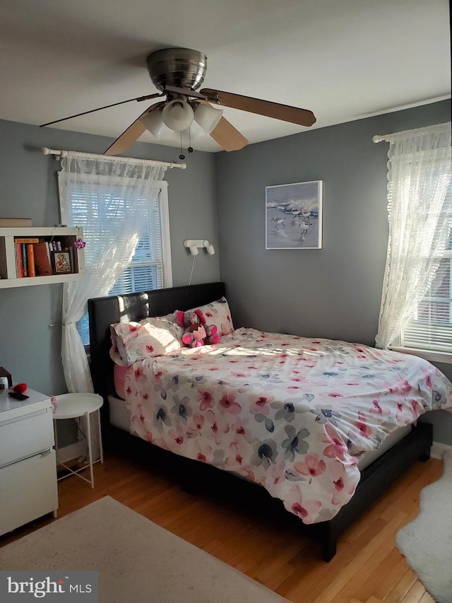 bedroom featuring wood-type flooring and ceiling fan