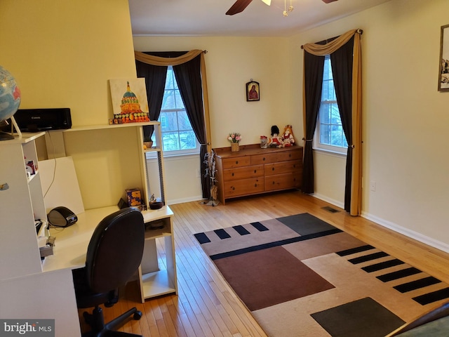 office space featuring ceiling fan and light hardwood / wood-style floors