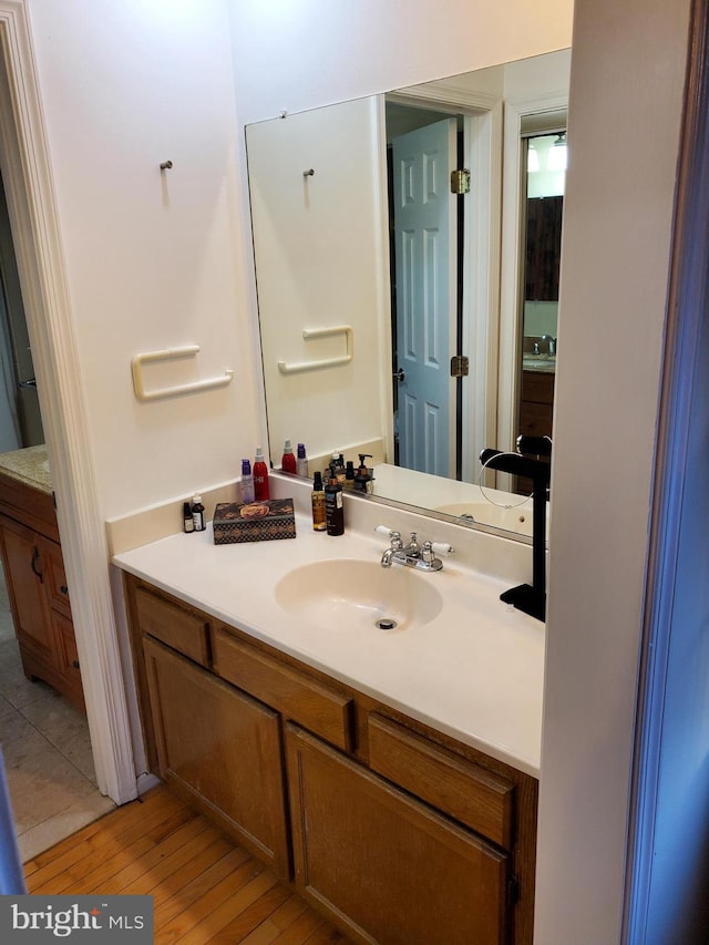 bathroom with hardwood / wood-style flooring and vanity