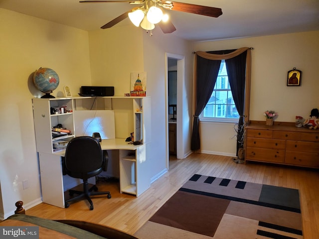 office area with light hardwood / wood-style flooring and ceiling fan