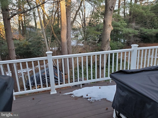 wooden deck with a grill